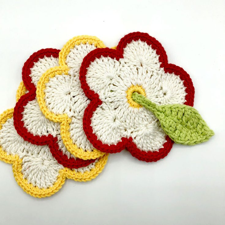 This coaster project begins with a starting ring of chain six. The middle section is made with tr stitches around, and the petals are formed with clusters of 11 tr stitches.