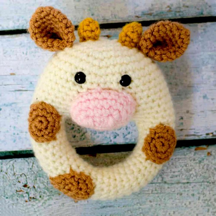 A crocheted cow rattle? Who'd have thought it? A newborn would love nothing more than to be company from a baby cow! It's only 5 inches tall (not counting the ears) and 4.5 inches wide, but that's all up to how thick your yarn is.