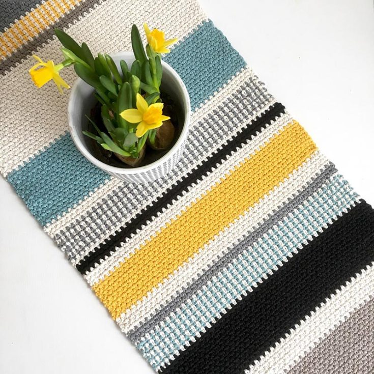 This table runner is made using the crochet moss stitch. Moss stitch is simply an alternating chain and single crochet stitch. It may be a new stitch to learn, but you'll get the hang of it after a while. The moss stitch, together with a thicker cotton yarn, gives a great texture as a runner.