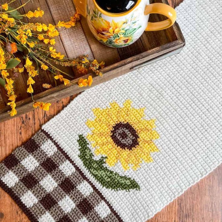 A more rustic farmhouse approach to spring would be with this gingham table runner with sunflowers. The gingham ties in beautifully with the subtle muted colors of the sunflower.