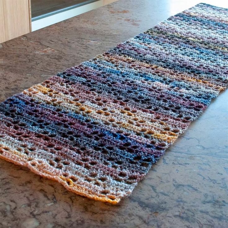 This pattern has a fun texture with window pane-like motifs. The variegated yarn used makes this stand out from other table runners, and it will subtly stand out on your tables.
