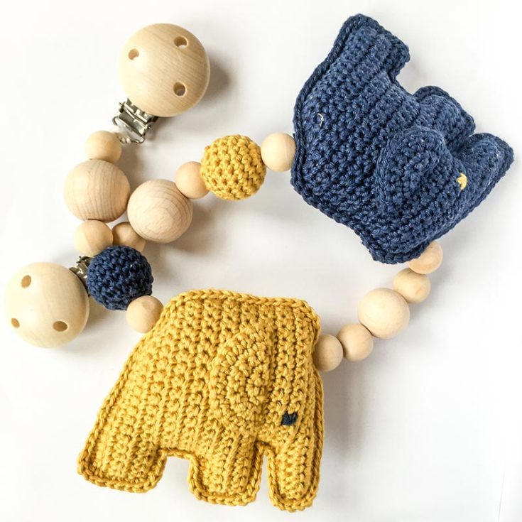 Anyone in search of a charming and functional baby item can benefit from taking on this crochet elephant stroller toy. Attaching it to a wooden ring makes it a simple and fast project, and the kids will love playing with it.