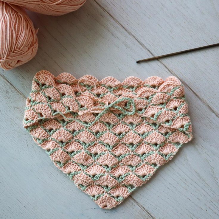 This shell bandana uses an excellent crochet technique where you work crochet chain framing like a "scaffold," so your shells can be built upon it. Sure, it may take a little practice to get ahold of this stitch and pattern, but you'll get a lovely, unique piece in the end! This piece measures 18&Prime;&nbsp;(46cm) along the long side.