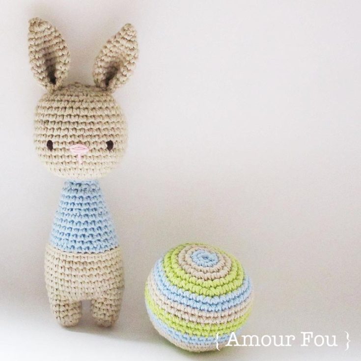 Learn how to crochet this pretty soft-colored bunny rattle and ball for entertaining playtime for babies or kids. It's quite an easy project as the pattern mainly works in rounds and uses only chain stitches, slip stitches, and single crochets.