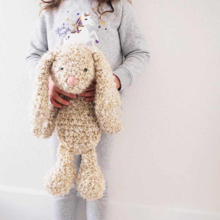 This huggable, floppy ear bunny is made using a curly cue and fleece-looking yarn that may be hard to work with as a first-timer. But it contributes to the soft, natural, furry look, and it's perfect as a snuggle toy!