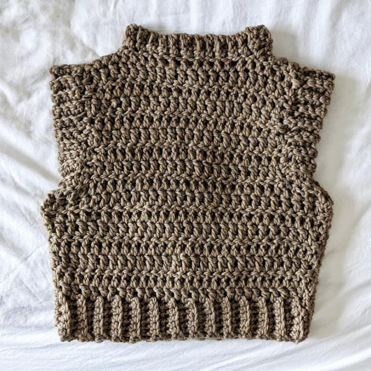 This crochet sweater vest has a high neck with lovely stitching that makes it stand out like a turtleneck. It comes in sizes XS to 3XL and is an excellent piece to layer! Try it out now.