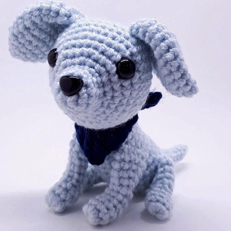 Brie, the dog, is a cute little crochet dog, but we are not really sure what breed of dog he is. He comes in a special pale blue color, but you can also make him in a traditional dog color! This is an intermediate-level pattern that is made in 9 separate pieces.