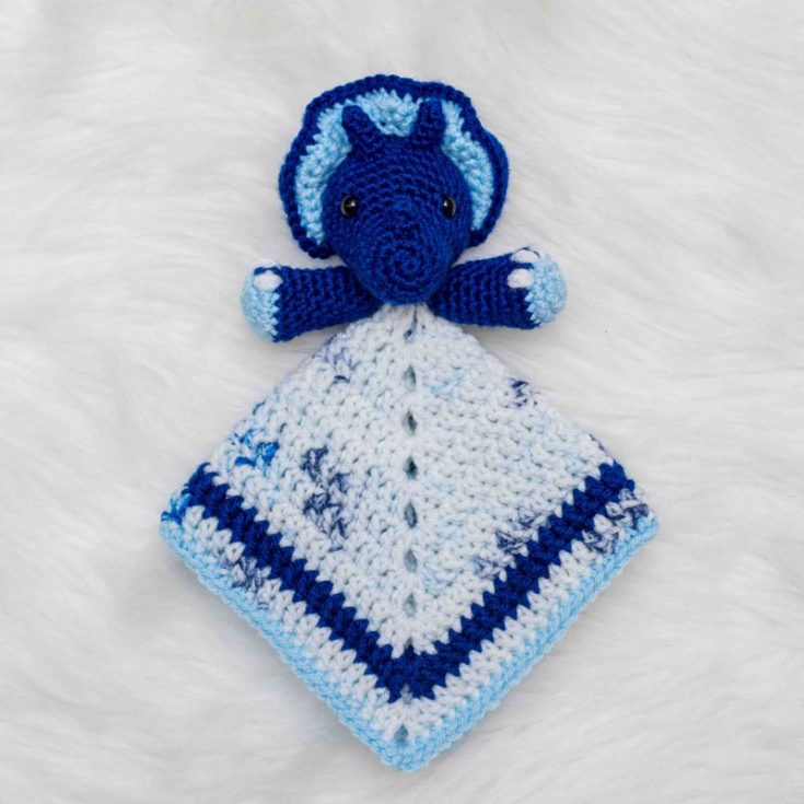 Have a fun time making this creative triceratops pattern. This crocheted blanket design is an advanced beginner pattern, and the finished size measures up to 11" square, 4" tall for the head, and 5" for the arm span.