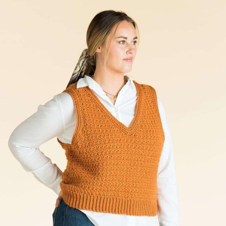 This crocheted vest pattern is an intermediate-level vest, perfect for chilly days. With a narrower shoulder strap than most vests, this one explodes with texture created by the trinity stitch. It comes in sizes XS-5XL.