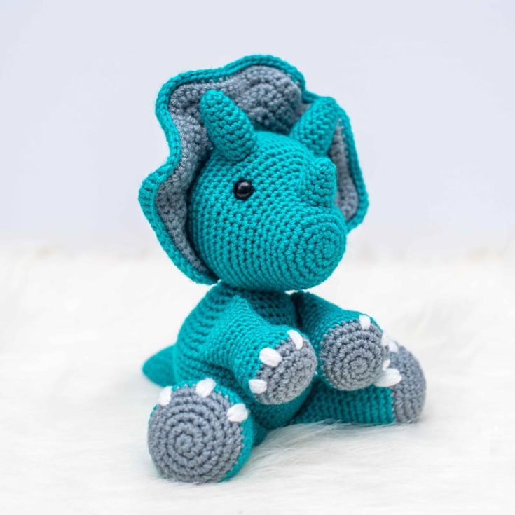 Tanner, the triceratops, has his iconic mane-like structure, and the design is a beginner's amigurumi! He is approximately 10 " tall when sitting down and about 13" tall when standing.