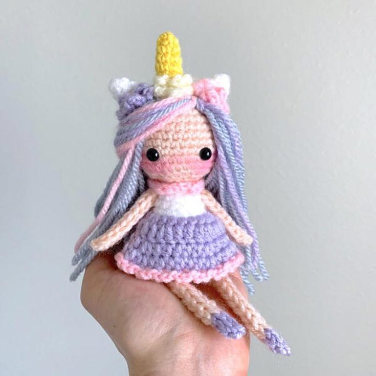 Check out this gorgeous unicorn pixie amigurumi girl doll! She&rsquo;s so easy and quick to crochet, and she is pocket-sized. How cute is that? She is adorned with a unicorn horn, a flower crown, purple hair highlights, and a lazy frill skirt. She is open to customization, so go wild with this pattern!