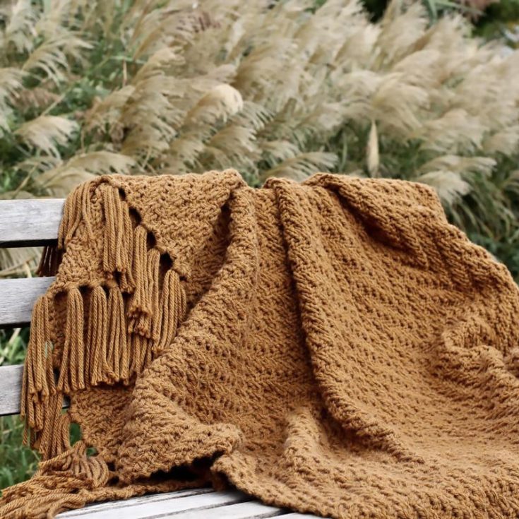 Now, this Harvest Throw Blanket is one of our favorites! If you&rsquo;re an indie girl and love an &ldquo;Autumn Girl&rdquo; moment, this design will definitely be the one you&rsquo;ll choose. It&rsquo;s entirely beginner, which makes it the perfect knit project to start on, and it features a simple chevron texture that makes the blanket extra squishy and soft. You can also add fringes to add flair and drama to this blanket, and the finished size is 42&rdquo; x 56&rdquo;.