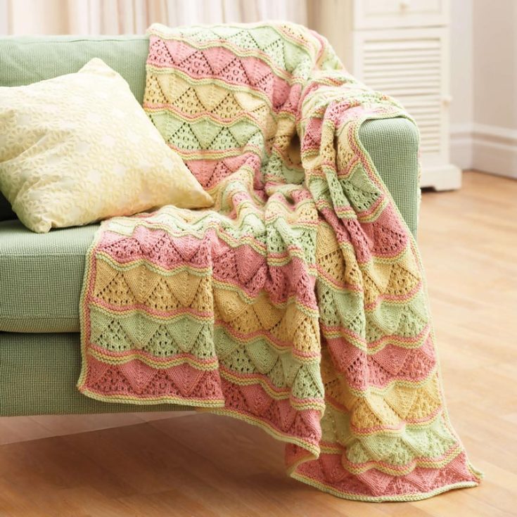 Doesn&rsquo;t this blanket remind you of watermelons? Imagine having a picnic with your friends, laying on this gorgeous Lacy Waves Afghan, and gazing up at the clear blue sky with trees far in the distance. This lovely blanket perfectly encapsulates that tranquil vibe with its triangle lace pattern and soft multicolored stripes. With this downloadable PDF, you&rsquo;ll follow all the step-by-step instructions to replicate a cozy blanket that will soon be a favorite in your family. The finished size is 47&rdquo; x 58&rdquo;.