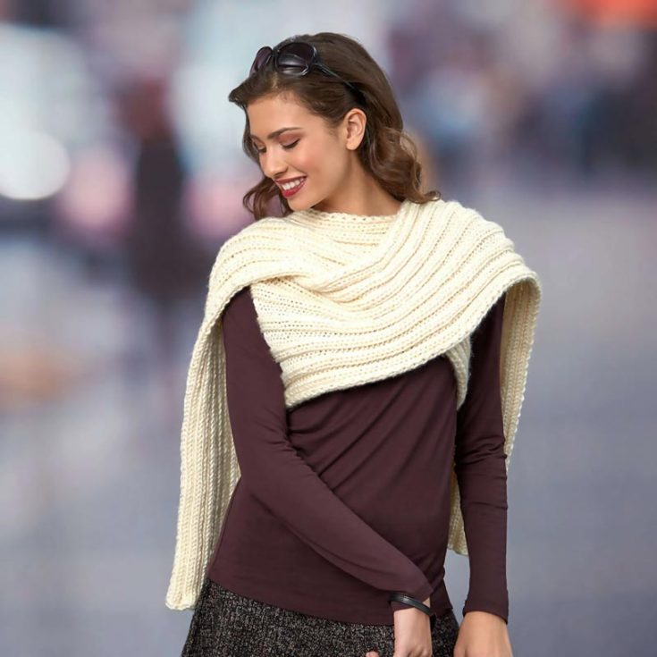 If you&rsquo;re interested in easy scarf knitting patterns with a simple variation to the classics, this pattern is just what you&rsquo;re looking for! This elegant and fashionable design can be worn in many ways! You can let it drape over your shoulders or slide your arms through the armholes for an accent piece to your outfit.