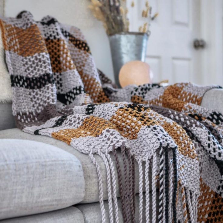 This Moonstone Plaid Blanket is a cozy and elegant project perfect for any season and occasion. Combining soft, neutral hues with a classic plaid design and simple weaving technique, this blanket brings a stylish flair to your space. Whether to drape it over a couch or to snuggle in by the fireplace with a good book, this pattern would be a delightful addition to any home. The finished dimensions of this blanket are 46&rdquo; x 56&rdquo;.
