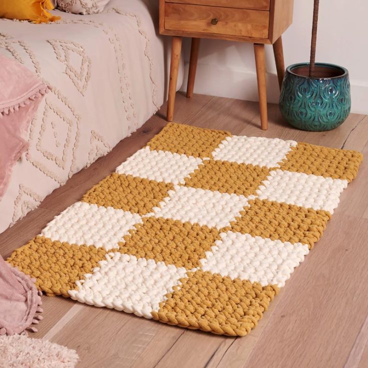We're finally making our way to some rectangular rugs. Check out this fun crochet checkerboard rug that provides you an opportunity to master crochet intarsia. It works up relatively fast, too, with the use of chunky yarn.