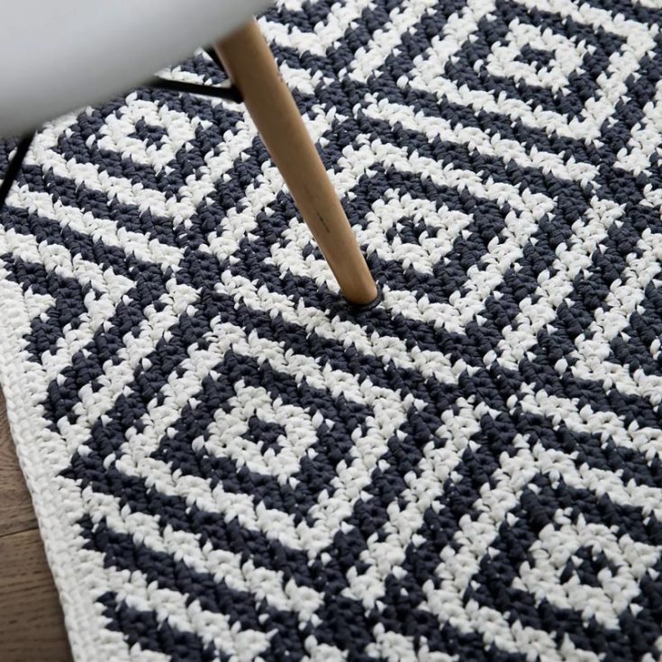 Is your home looking a little plain? Spice it up with this geometric-patterned modern tapestry crochet rug. Made using the tapestry crochet technique, the pattern includes a video tutorial that will teach you how to replicate it step-by-step!