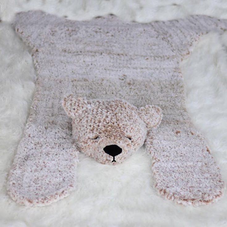 This adorable furry bear blanket rug can be crocheted as a throw, a blanket, a playmat, or a nursery rug. If you feel intimidated by using faux fur yarn, this pattern includes a tutorial to teach and guide you through everything you need to know!