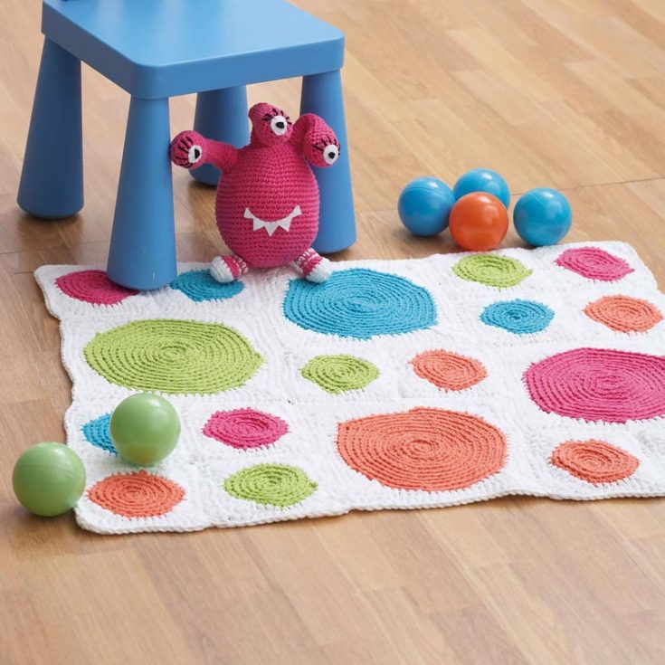 This colorful spotted rug adds a playful vibe to any space. It is a beautiful crocheted mat for the playroom or your child's room.