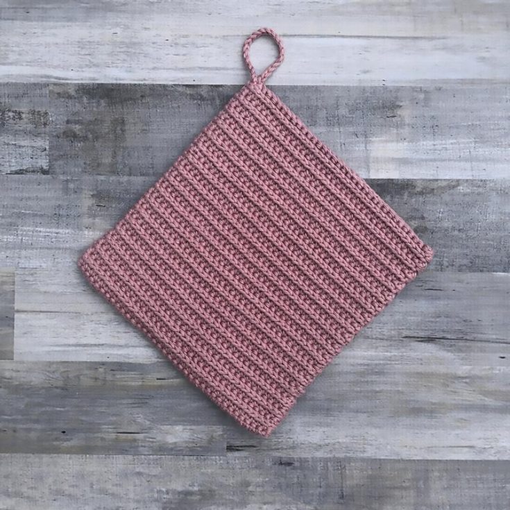 Give your crochet potholder a professional, store-bought look by working them in the round so you get that rounded double layer of thickness. This potholder design has a ribbing texture made by half-double crochets, and it's sleek, modern, and suitable for beginners. The finished size is 7.75" x 7.75".