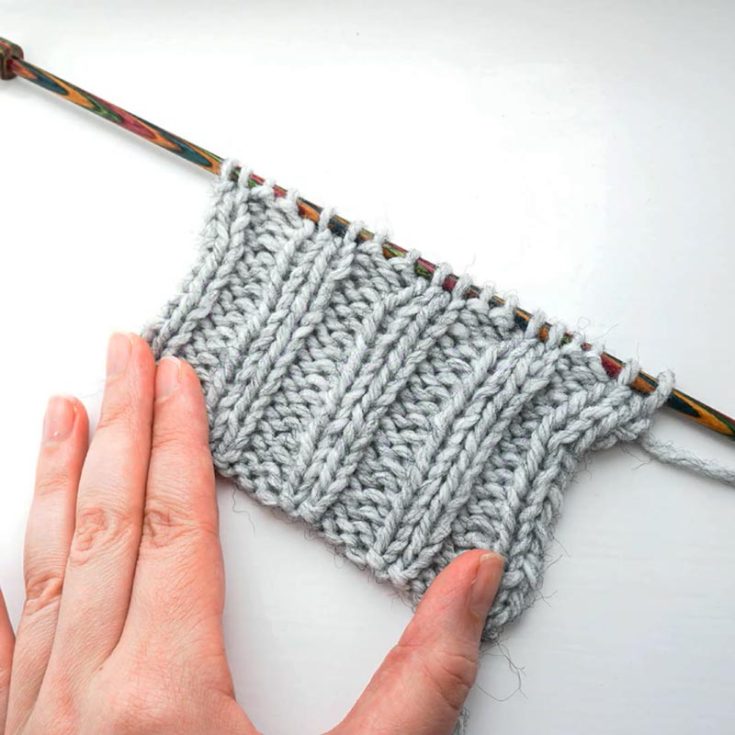 This is similar to the 1x1 Rib Stitch. Instead, this 2-row repeat pattern alternates two knit and purls in each row. It produces beautiful 3D vertical stripes that are stretchy, elastic, and perfect for hems and cuffs.