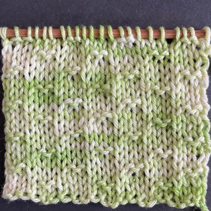 The Double Fleck Stitch is a 4-row repeat that is not reversible and is worked on a multiple of six plus four cast-on. It has vertical columns on a Stockinette background, and the pattern is made from knit and purl stitches.