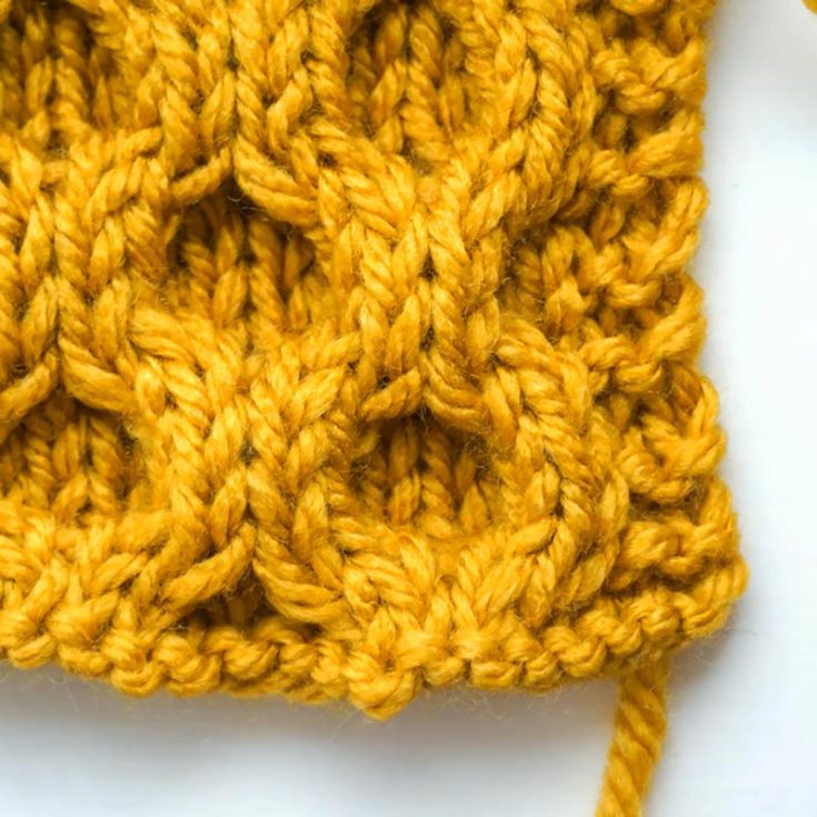 This is one of the most stunning stitches on the list. The Honeycomb Cable Stitch is an 8-row repeat pattern that is not reversible, and it creates a lovely 3D effect with interlocking textures.