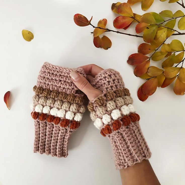 Here's another beginner-friendly crochet pattern. These fun bobble stitch fingerless crochet gloves are fun and festive, especially if made in holiday colors. Use DK yarn and a 4mm hook for child-size gloves.