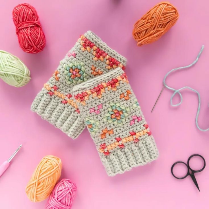 What could be cozier than these vibrant, hygge mitts? Once you've crocheted the block for your wrist, you'll add a colorful cross-stitch pattern. Finally, sew the fingerless mitts into a tube, and you're all set!