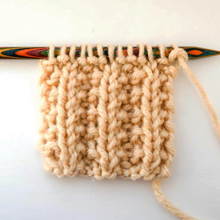 The Seeded Rib Stitch is a variant of the Seed Stitch and a 2-row repeat. It&rsquo;s a reversible design that produces a squishy and stretchy fabric. It is made with columns of Seed Stitches between columns of ribbing.