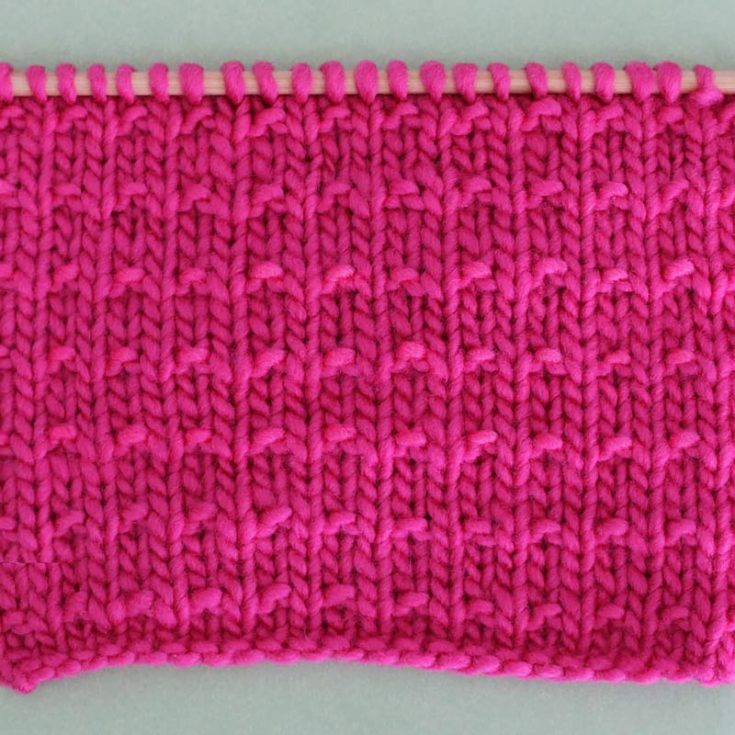This 4-row repeat stitch creates subtle textures on the fabric by combining knit and purls to create a raised pattern. It is not a reversible pattern, and the edges curl. However, add a Garter or Seed stitch for the borders to make it lay flat.