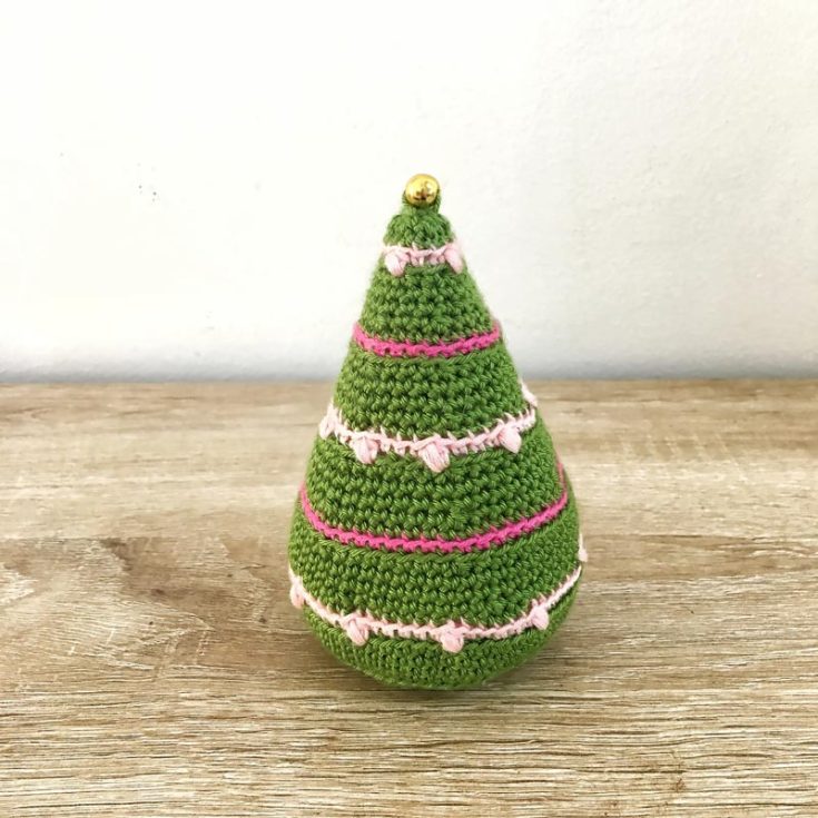 This amigurumi Christmas tree pattern is worked from the bottom top, with rows of color to give the impression of hanging lights. This pattern also calls for no sewing except for the button at the top.