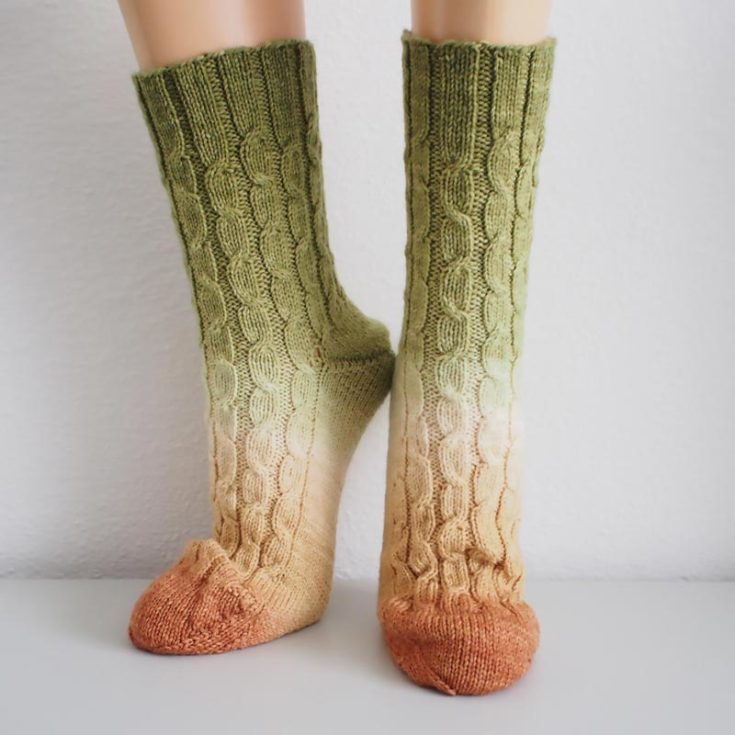 Check out this fantastic, easy, and basic sock design! It's a lovely ombre look and a unisex pattern. It features the German Short Row heel and toe construction in the eat-to-follow instructions in the downloadable PDF. These pair of socks fit Eur sizes 38 to 40, with a circumference of 8" / 9" to fit feet with a circumference of 8" -9" / 9" -10".&nbsp;