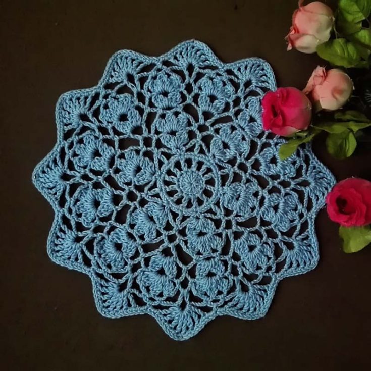 This 12" flower wheel doily is not for the faint-hearted! It features a big circular wheel spread out like a flower with intricate patterns, making it a more suitable project for intermediate-level crocheters.