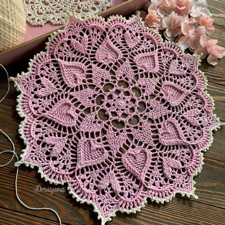 The outer edge of this doily showcases a contrasting color, adding a touch of elegance and a polished finish. This intermediate to advanced level piece is perfect for a romantic touch in any room. A heart-filled design that is sure to impress!