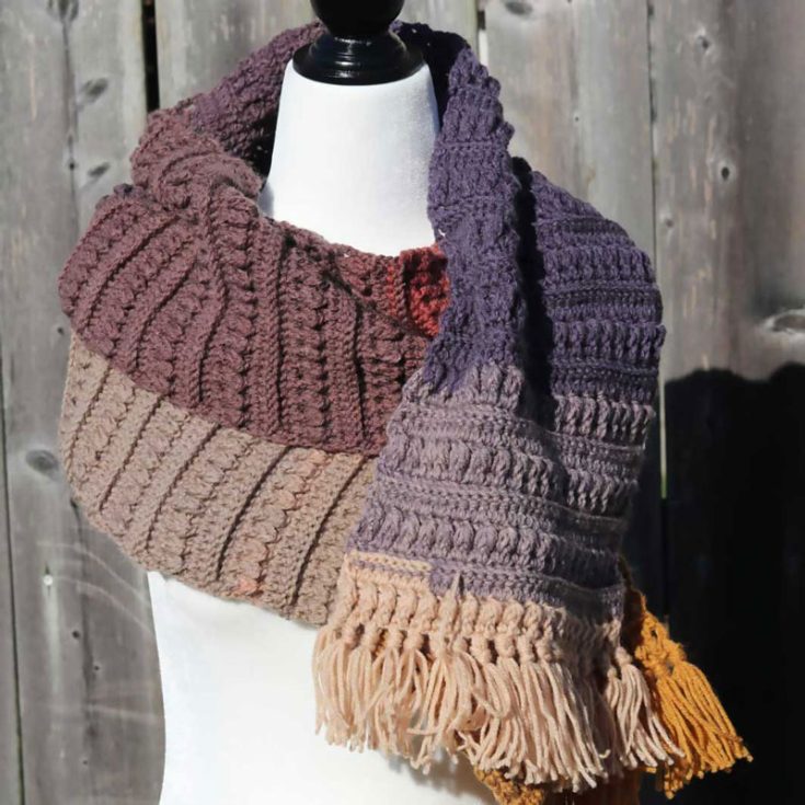 The pine cone scarf is created by working rows of post stitches alongside some front post puff stitches, It is not as hard as it sounds, we promise. The little puff stitches are inspired by little pine cones!
