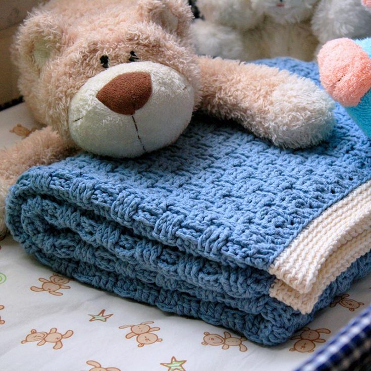 This pretty baby blanket uses a basketweave stitch pattern that resembles the texture of a wicker basket. This is an intermediate-level pattern that yields 42&Prime; wide, 33&Prime; long baby blanket.