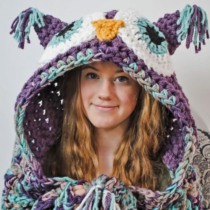 Wrap yourself in a cozy hooded owl blanket that transports you to a warm wonderland! This crochet pattern features a beautiful shell stitch design and is available in toddler, child, and adult sizes.