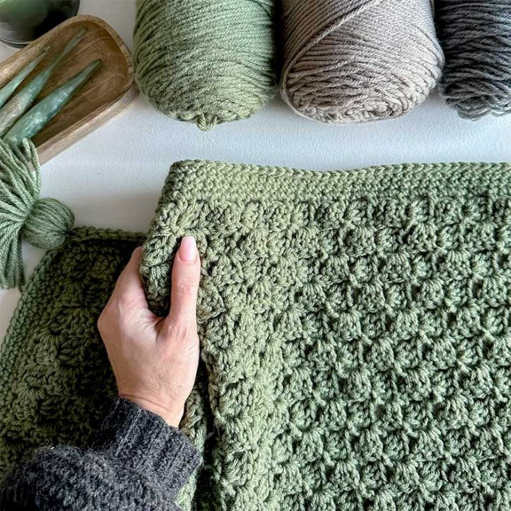 Learn to crochet this modern C2C blanket. This modern design works its magic diagonally with double crochet stitches. The pattern includes a written pattern and a video tutorial for both a bulky and medium-worsted-weight version.