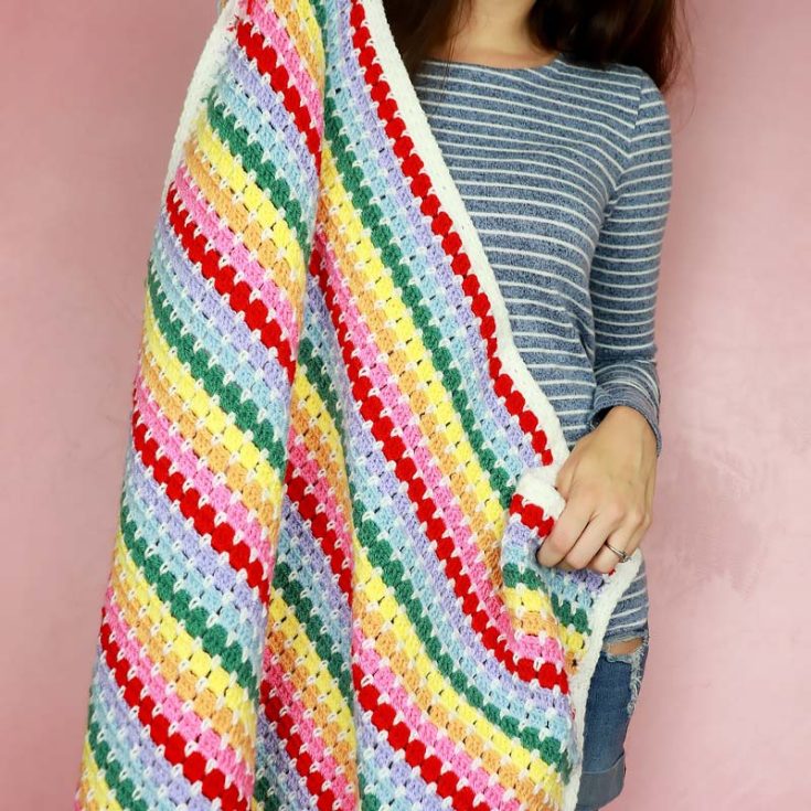 Make a cozy, gender-neutral blanket with the timeless block stitch, combining single and double crochet stitches. Perfect for any skill level, and with a little patience, you&rsquo;ll have it finished in no time!