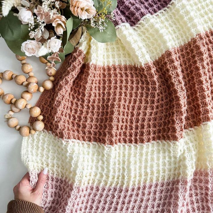 Wrap yourself in cozy vibes with this modern waffle stitch blanket! Its squishy texture is oh-so-satisfying, made with simple double crochet and front post double crochet stitches. Plus, there&rsquo;s a step-by-step video tutorial on YouTube to guide you through the magic.