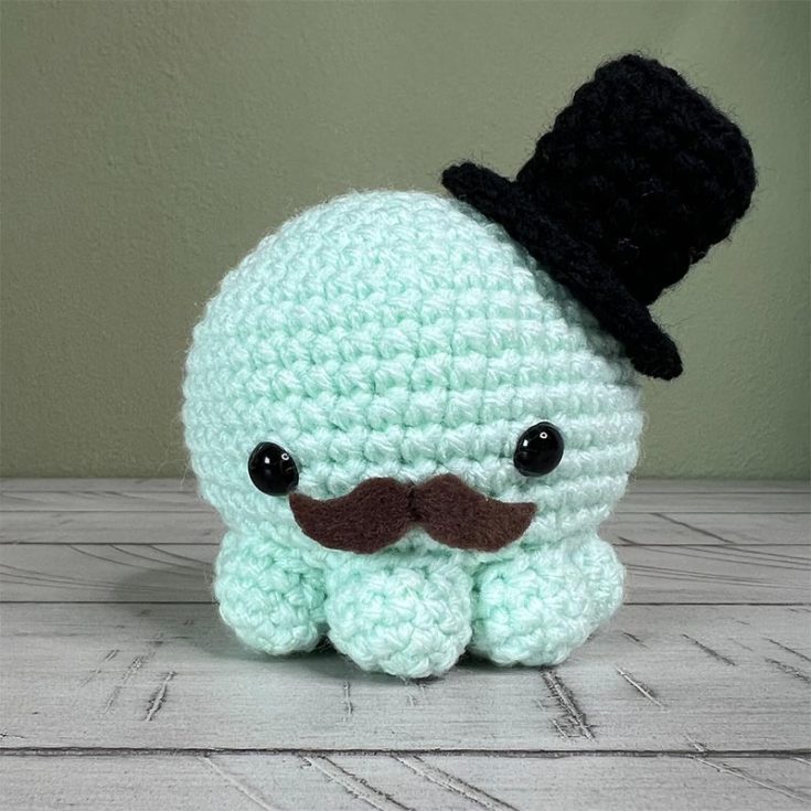 This crochet octopus is absolutely adorable, and the top hat and mustache make it even more delightful and dapper. It's the perfect mix of cuteness and charm!
